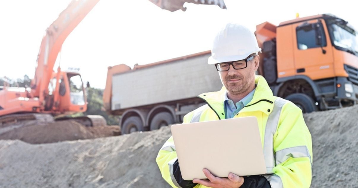 Engineer filling out mobile form on constrution site