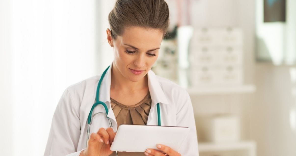 Female doctor filling out a mobile form