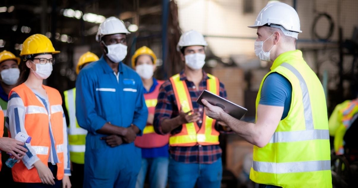 Site manager encouraging team members to comply with safety guidelines to prevent risks