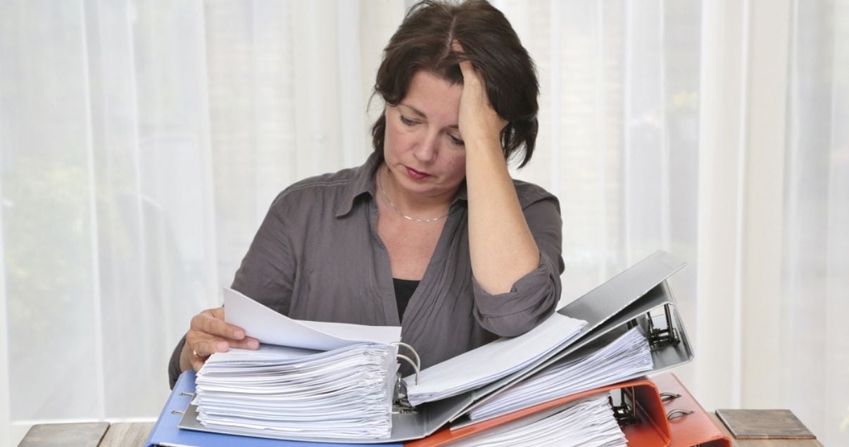 Female worker stressed out due to paper forms