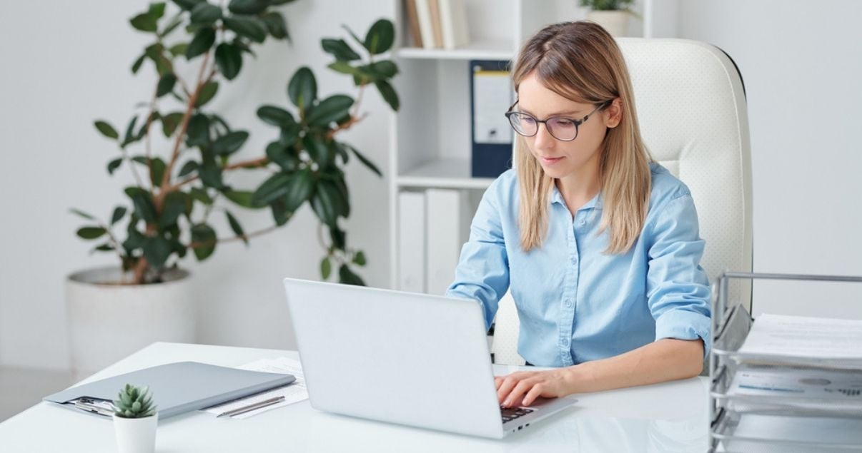 Young blond woman analysing information after collecting data