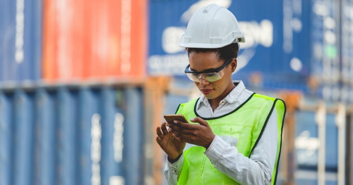 Female worker filling out a mobile form on site