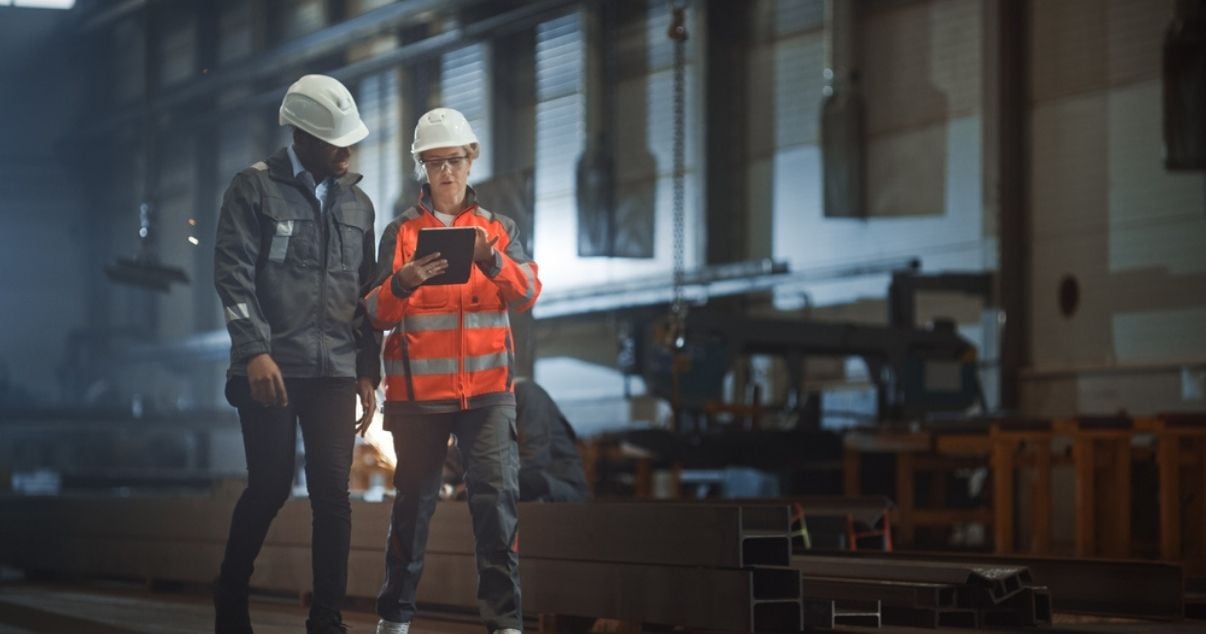 Male and woman engineers gathering information using smart forms