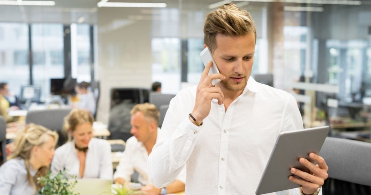 Male businessman using checklists to boost productivity at his organisation