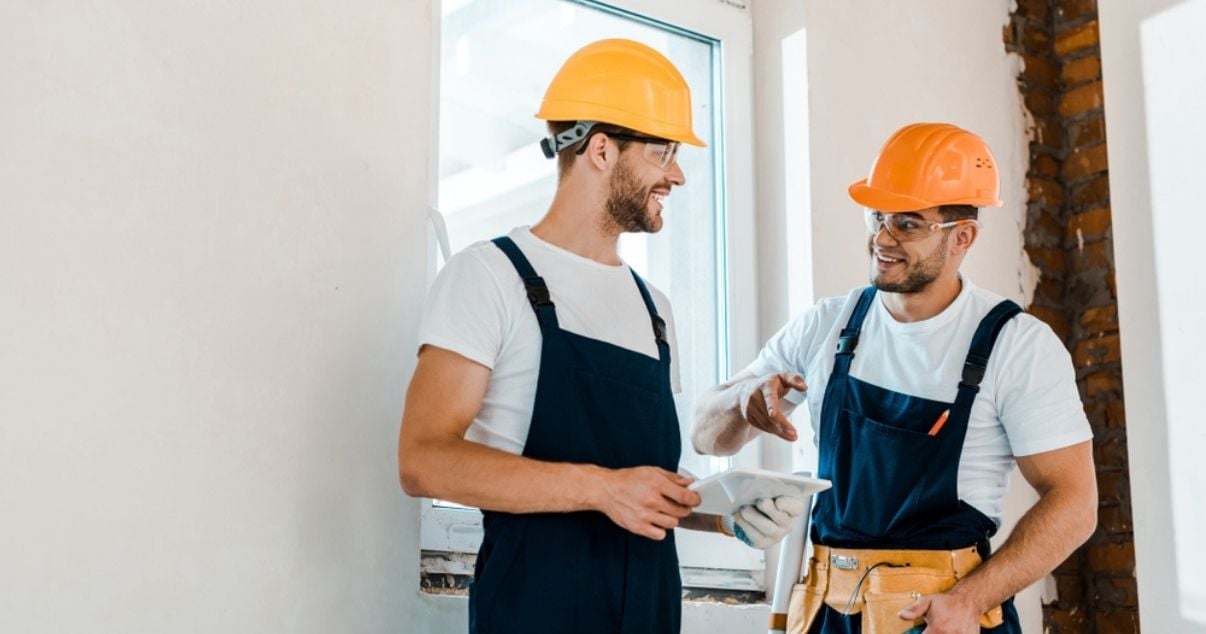 Male construction workers taking advantage of mobile forms smart features to increase their productivity