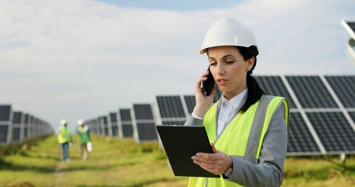 Female engineer collecting data on her tablet using mobile forms