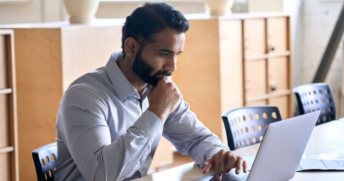 Male businessman focused on managing profiles on his Kizeo Forms platform