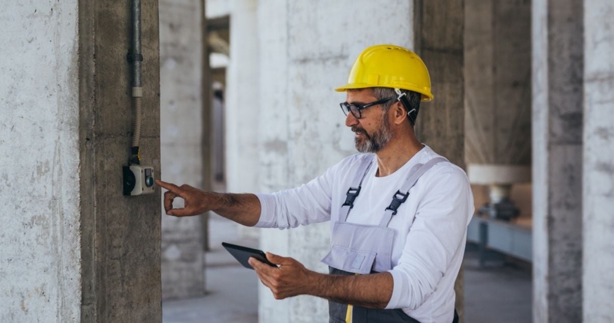 Male engineer collecting information using mobile forms