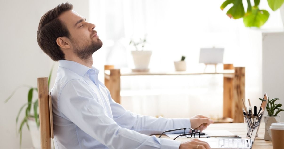 Young brunette businessman relieved after having recovered organisational data using Kizeo Forms