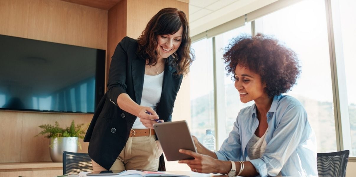 Female co-workers analysing organisational insights collected though mobile forms