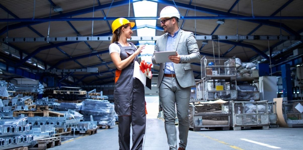 Male and female engineers discussing data collected thouh mobile forms