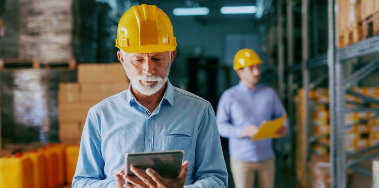 Middleaged male inspector performing a site audit using mobile forms