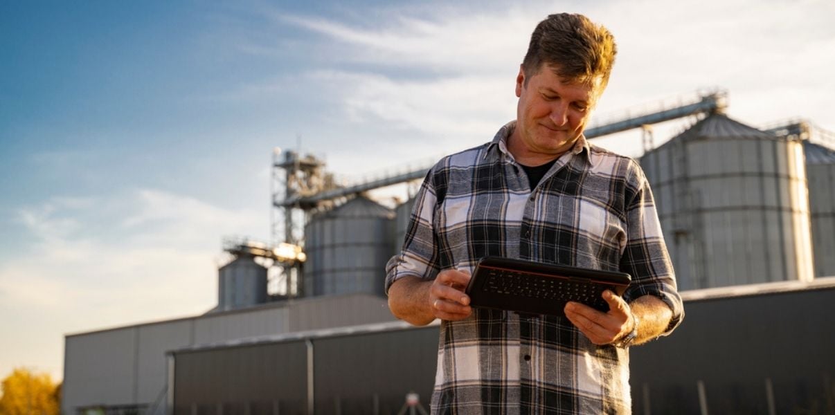 Satisfied male agricultural engineer boosting his farm management through mobile forms