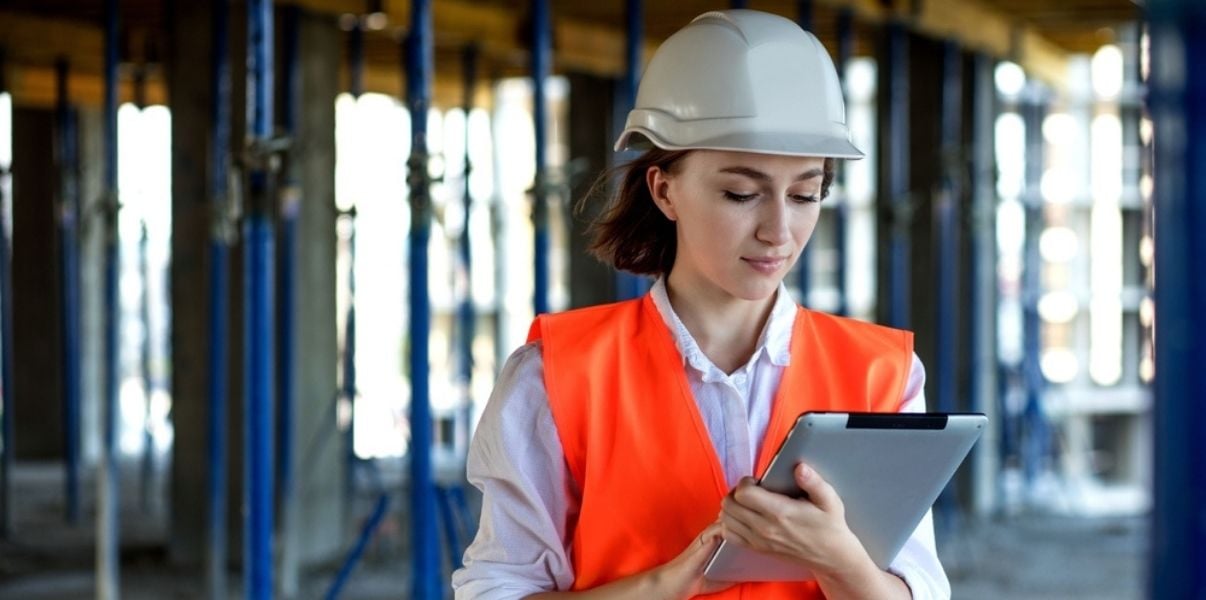 Young woman performing a site inspection using mobile fomrs on her tablet